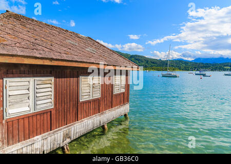 Wooden traditional boat house on shore of Worthersee lake in summer, Austria Stock Photo