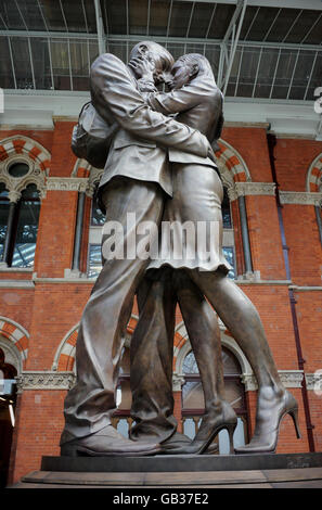 Stock: The Meeting Place, a 30ft high bronze statue by British artist, Paul Day, that stands in London's St Pancras Station. Stock Photo