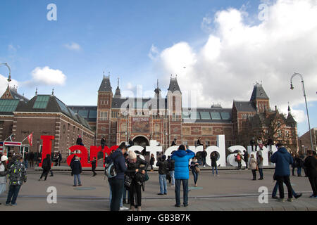 AMSTERDAM, THE NETHERLANDS - FEBRUARY 29,2016 The tourists take photo in front of the Rijksmuseum (National state museum), a pop Stock Photo