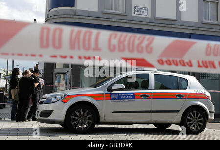 A general view of the scene on Penrose Street in Southwark, south east London, today, where an as yet unnamed man has been found shot dead. The young man was shot dead just streets away from where a teenager was gunned down earlier this month, police said today. Stock Photo