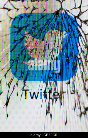 Twitter icon viewed through a smashed apple iphone screen UK Stock Photo