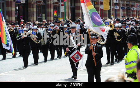 Police officers walk down Deansgate during Manchester's annual gay Pride parade, Manchester. Stock Photo