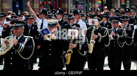 Police officers walk down Deansgate during Manchester's annual gay Pride parade, Manchester. Stock Photo