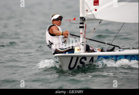 USA Laser Radial Gold medalist, Sheffield-born Anna Tunnicliffe, salutes her success in the final round of her regatta at the 2008 Beijing Olympic Games Sailing Centre off Qingdao, China. Stock Photo