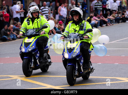 Gay Pride parade Manchester. Police officers ride mopeds along Deansgate during Manchester's annual gay Pride parade, Manchester. Stock Photo