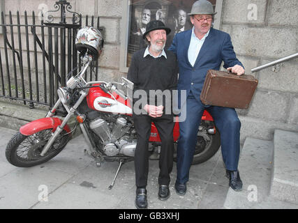 Cast Member Johnny Murphy (left) waits with Michael Colgan of the Gate Theatre, Dublin, on a motorbike for the photocall at the 'Waiting for Godot' tour bus. Stock Photo