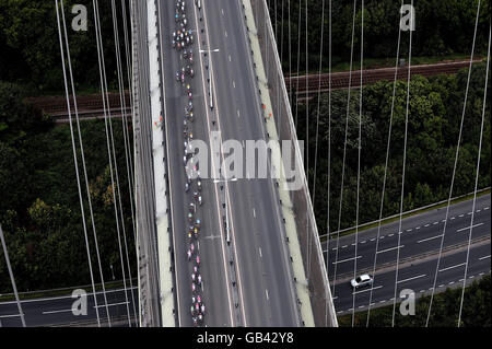 Riders cross the Humber Bridge during stage five of the Tour of Britain cycle race. Stock Photo