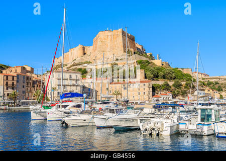 BONIFACIO PORT, CORSICA ISLAND - JUN 25, 2015: sailing yacht boats anchoring in Bonifacio port with citadel building in backgrou Stock Photo