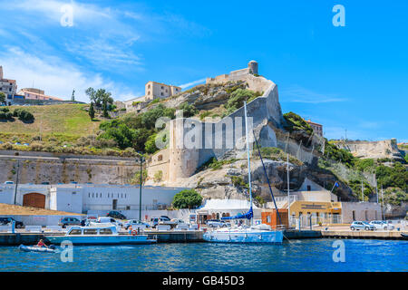 BONIFACIO PORT, CORSICA ISLAND - JUN 25, 2015: boats anchoring in Bonifacio port with citadel building in background. Bonifacio Stock Photo