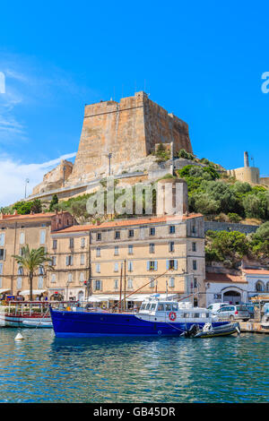 BONIFACIO PORT, CORSICA ISLAND - JUN 25, 2015: boats anchoring in Bonifacio port with citadel building in background. Bonifacio Stock Photo