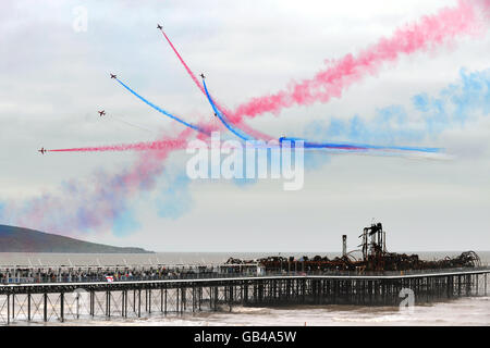 Red Arrows display at Weston-super-Mare. The Red Arrows display over the fire damaged Grand Pier at Weston-super-Mare. Stock Photo