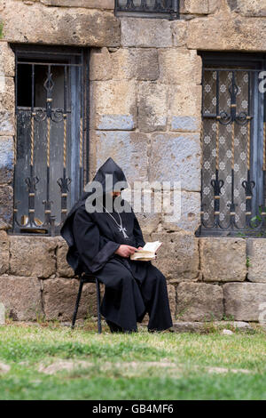 A monk reading a book at Tatev monastery in Armenia Stock Photo