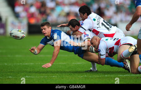 Hull FC's Lee Radford (in blue) releases the ball under pressure from the Hull KR defence during the engage Super League match at Craven Park, Hull. Stock Photo