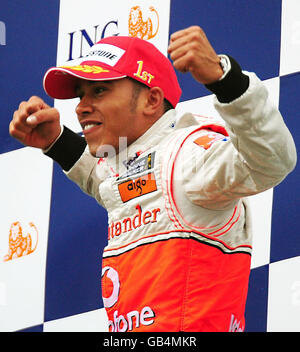 McLaren Mercedes' Lewis Hamilton of Great Britain celebrates on the podium after winning the Belgian Grand Prix at Spa Francorchamps, Belgium. Stock Photo