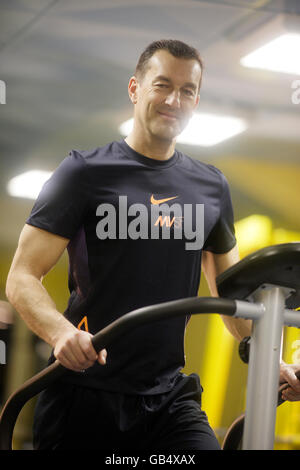 Man running on a treadmill in a gym Stock Photo