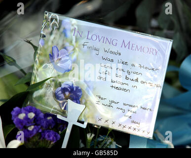 A tribute left on a card with flowers for Finlay Woods, left outside with other floral tributes outside Selwyn Junior School in Highams Park in East London. Stock Photo