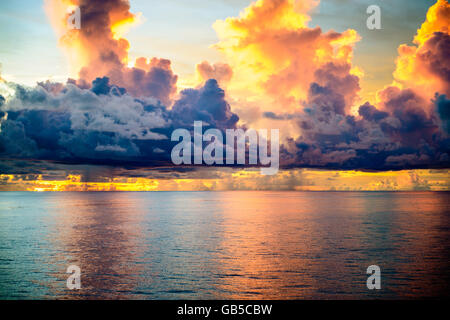 A dark sky with an amazing array of storm clouds with calm seas. Image was captured in the pacific ocean of the coast of Guam. Stock Photo