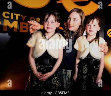 Academy Award nominee Saoirse Ronan with twins Catherine and Amy Quinn, who play her little sister, arriving for the film premiere of City of Ember in Belfast. Stock Photo