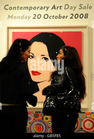 Visitors view Portrait of Laura Coppet, by Andy Warhol, at Sotheby's London auction rooms. Stock Photo