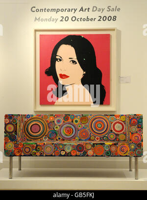 Portrait of Laura Coppet, by Andy Warhol, overlooks Sushi Sofa, by Brazilian designers Fernando and Humberto Campana, at Sotheby's London auction rooms. Stock Photo