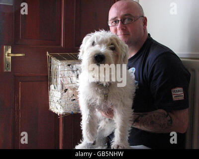 Pet owner Mark Monroe, 44, with his 12-year-old Jack Russell 'Jack' at his home in Lemington, Newcastle upon Tyne. Mr Monroe is being sued for 15,000 by Brian Hunter, who claims the dog bit off part of his little finger when he delivered a leaflet to his home in November 2006. Stock Photo