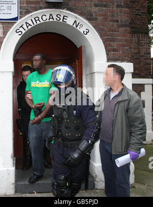 Police officers conduct raids on various addresses in Peckham, south London, several robberies by a gang at betting shops, amusement arcades, and pubs, using offensive weapons with violence over the last two years, this morning. Stock Photo