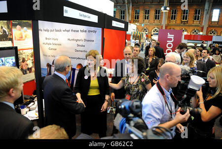 Prime Minister Gordon Brown's wife Sarah Brown, centre in yellow top, tours exhibition stands inside Manchester Central, during the second day of the Labour Party conference in Manchester. Stock Photo