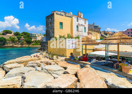 SAINT FLORENT, CORSICA ISLAND - JUN 30, 2015:tourist dining in restaurant in small port of Saint Florent, Corsica island, France Stock Photo