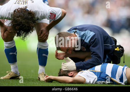 Reading's Noel Hunt receives treatment after scoring the opening goal of the game against Burnley during the Coca-Cola Championship match at the Madejski Stadium, Reading. Stock Photo