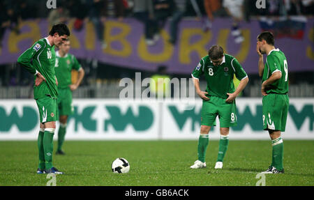 Northern Ireland's Kyle Lafferty (left), David Healy (centre) and Steven Davis appear dejected during the World Cup Qualifying Group match at the Ljudski Vrt Stadium, Maribor, Solvenia. Stock Photo