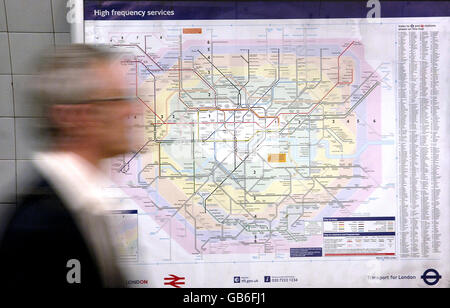 Tube workers to be balloted for industrial action. A person walks by a London Underground tube map. Stock Photo