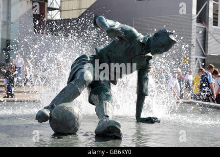 A statue of Preston North End's Tom Finney splashing through a puddle on show outside the National Football Museum Stock Photo