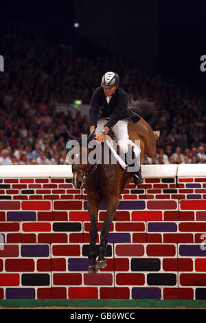 Netherland's Jurgen Stenfert riding BMC Vayom competes in the Puissance on day four of the Horse of the Year show at the NEC arena in Birmingham. Stock Photo