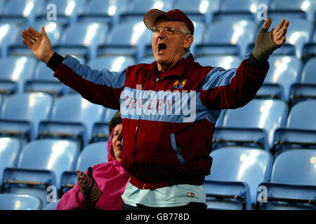 A Burnley fan shows his support, in the stands prior to kick off. Stock Photo