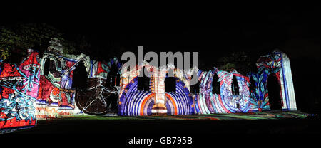 The medieval ruins of St Mary's Abbey in York are illuminated as part of the Illuminating York Festival. The piece of art, by projection artist Ross Ashton, called 'Accendo', is accompanied by music and sound effects and is designed to explore the relationship between science and religion. Stock Photo