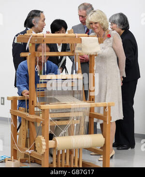 The Prince of Wales and the Duchess of Cornwall, view a demonstration of spinning on a loom, as they visit the craft museum in Nara, Japan. Stock Photo