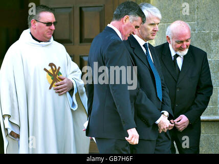 Richard O'Kennedy, second right, leaves a requiem mass held at Holy Family Catholic Church in Patchway, Bristol, for family members who died in a plane crash in Ireland. Stock Photo