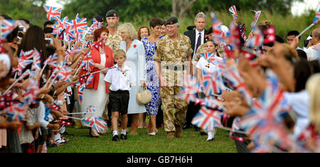 The Prince of Wales and the Duchess of Cornwall are greeted by the families of Gurkha soldiers, after arriving at the Gurkha ceremony at the Seria Garrison in Brunei, south east Asia. Stock Photo