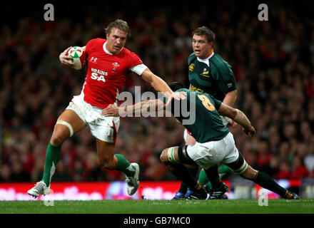 Wales' Andy Powell hands off South Africa's Pierre Spies during the Invesco Perpetual Autumn Series match at the Millennium Stadium, Cardiff. Stock Photo