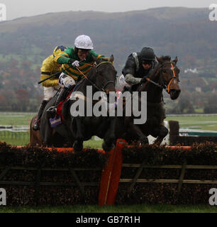 Jamie Moore (right) on Numide clears the last and wins after tussling with Tony McCoy on Aigle d'Or (white cap) who finished second in the Greatwood Handicap Hurdle during The Open at Cheltenham Racecourse. Stock Photo