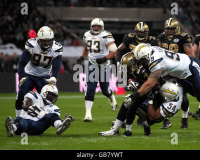 San Diego Chargers Defensive Lineman Igor Olshansky (right) attempts to bring down New Orleans Saints Running Back Pierre Thomas during the NFL match at Wembley Stadium, London. Stock Photo