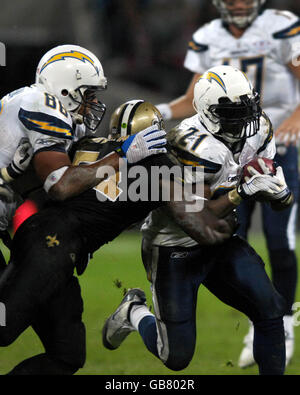 San Diego Chargers Running Back LaDainian Tomlinson is brought down by New Orleans Saints Linebacker Jonathan Vilma during the NFL match at Wembley Stadium, London. Stock Photo