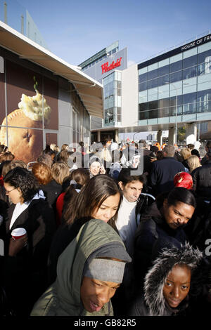 Shoppers wait in line to enter the Westfield Shopping Centre in White City, west London, on its opening day. Stock Photo