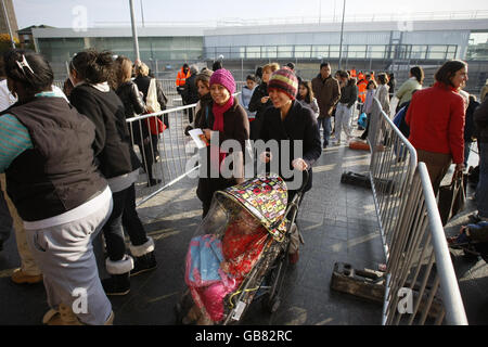 Shoppers wait in line to enter the Westfield Shopping Centre in White City, west London, on its opening day. Stock Photo