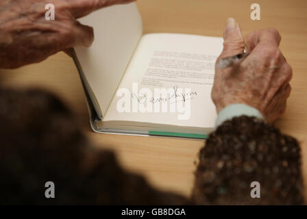 Dame Vera Lynn signs a copy of 'Voices of the Poppies - an anthology from Forces Poetry' at the Jubilee Library in Brighton. Stock Photo