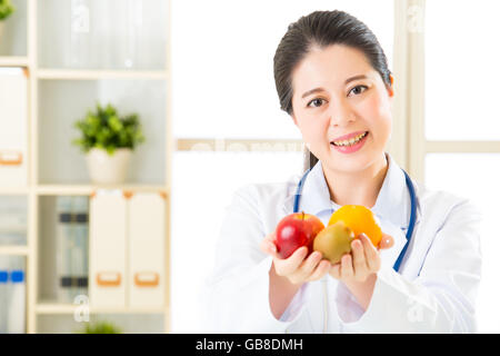 Young asian nutritionist holding  diet and helthy food, healthcare Stock Photo