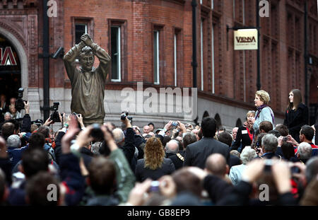 Fans gather around a statue of Nottingham Forest's legendary manager Brian Clough which was unveiled by his widow Barbara in the city's Old Market Square area today. Stock Photo