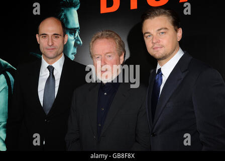 Leonardo DiCaprio, right, with director Ridley Scott, centre and British actor, Mark Strong arrive for the UK film premiere of 'Body of Lies' at the Vue West End, in central London. Stock Photo