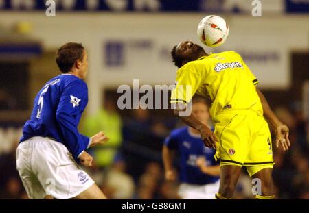 Charlton Athletic's Jason Euell controls the ball on his chest as Everton's David Weir looks on (l) Stock Photo