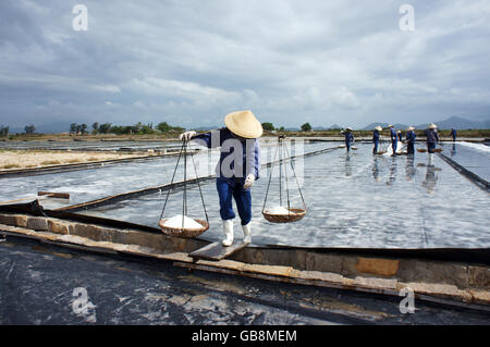 BA RIA, VIET NAM- FEBRUARY 3: Salt worker working on salina,they harvesting white salt in  Ba Ria, Viet Nam on February 4, 2013 Stock Photo